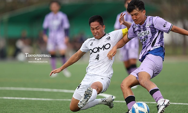 写真：SHIBUYA・伊藤のシュートを懸命に止めにかかるEDOのCB黒柳。